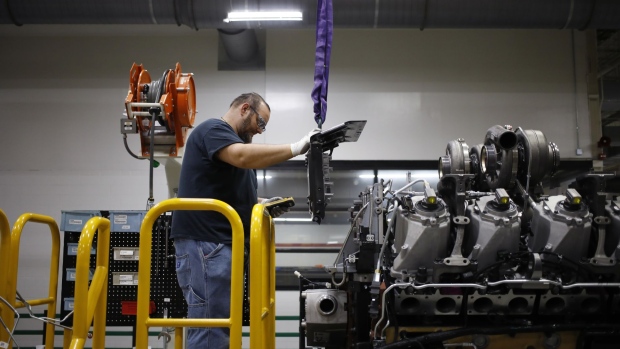 A worker assembles components on a diesel engine at the Cummins Seymour Engine Plant in Seymour, Indiana, U.S., on Monday, April 18, 2022. S&P Global is scheduled to release manufacturing figures on April 22. Photographer: Luke Sharrett/Bloomberg