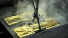 A worker plunges a gold ingot into a cooling bath at the Uralelectromed Copper Refinery, operated by Ural Mining and Metallurgical Co. (UMMC), in Verkhnyaya Pyshma, Russia, on Thursday, July 30, 2020. Gold surged to a fresh record Friday fueled by a weaker dollar and low interest rates. Silver headed for its best month since 1979. Photographer: Andrey Rudakov/Bloomberg