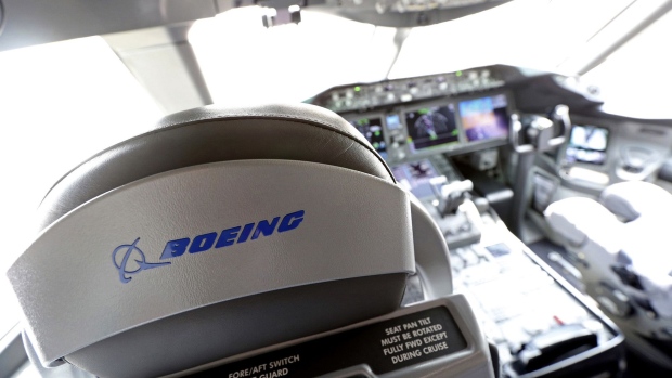 A logo sits on a pilot's seat in the cockpit of a Boeing Co. 787 Dreamliner