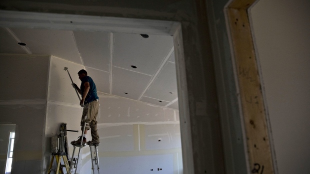 A finisher places tape on drywall seams inside a new home under construction in Plano, Illinois. Photographer: Daniel Acker/Bloomberg
