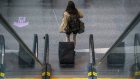 A traveler at Logan International Airport (BOS) in Boston, Massachusetts, U.S., on Thursday, April 21, 2022. Some transit agencies across the U.S. are clambering to adjust their masking requirements, while others are keeping the rules in place after a federal judge struck down the mandate for such coverings on planes, trains and other modes of public transportation.