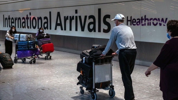 Passengers arrive at Heathrow Airport in London. Photographer: Chris J. Ratcliffe/Bloomberg