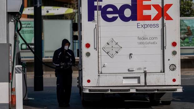 A driver fuels a FedEx delivery truck at a gas station in San Francisco, California.