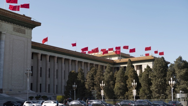 Flags fly atop the Great Hall of the People in Beijing, China, on Wednesday, March 6, 2019. Ongoing trade tensions with the U.S. and slowing growth have taken a toll on China’s economy. Those issues are dominating the National People’s Congress, an annual gathering of the country’s most powerful officials that continued Wednesday in Beijing. Photographer: Giulia Marchi/Bloomberg