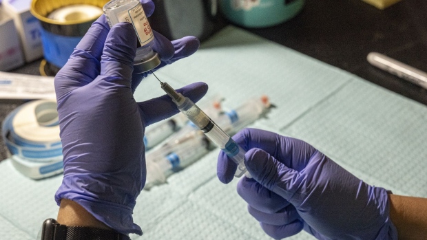 A healthcare worker wearing protective gloves fills a syringe with a dose of the Moderna Inc. Covid-19 vaccine at a vaccination site in Richmond, California, U.S., on Thursday, April 15, 2021. The California Department of Public Health has opened Covid-19 vaccination eligibility to persons 16 and older.