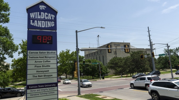 The temperature reads 98 degrees on Kansas State University signage in Manhattan, Kansas, US, on Friday, June 17, 2022. Cool and stormy weather at the corners of the US are helping trap heat across the Midwest and Mississippi Valley, where daily weather records are toppling as baking temperatures linger.