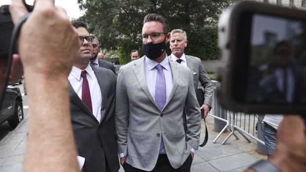 Trevor Milton, center, exits federal court in New York on July 29.