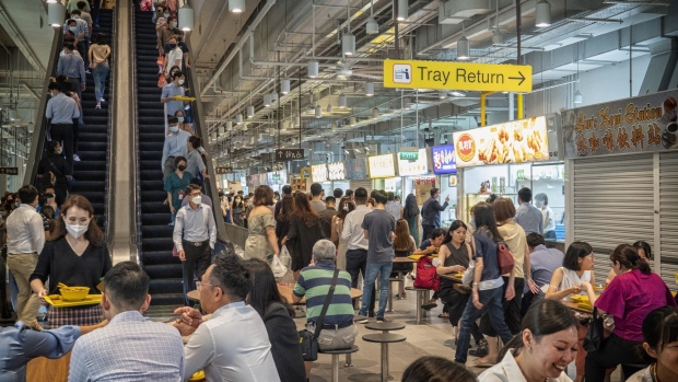 Customers at the Market Street Hawker Centre during lunch hour in Singapore, on Tuesday, April 26, 2022. Singapore began allowing all workers to return to the workplace and doing away with checking people’s vaccination statuses at most places.