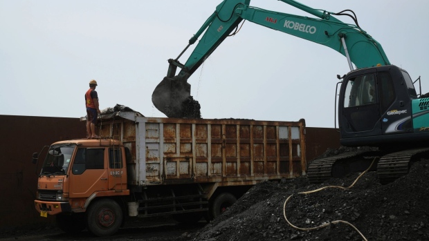 An excavator loads coal onto a dump truck at Cirebon Port in West Java, Indonesia, on Wednesday, May 11, 2022. Trade has been a bright spot for Indonesia, which has served as a key exporter of coal, palm oil and minerals amid a global shortage in commodities after Russia’s invasion of Ukraine.
