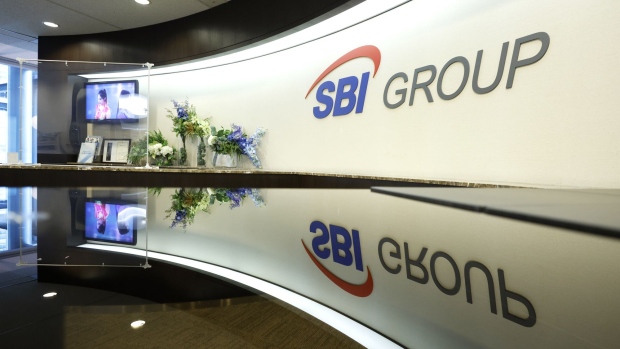 The group logo of SBI Holdings Inc. displayed at a reception area of the company's head office, in Tokyo, Japan, on Tuesday, Oct. 19, 2021. The Bank of Japan and Financial Services Agency are assessing if local financial institutions have any remaining Libor-linked contracts that will be difficult to shift to alternative interest rates before the benchmark expires.