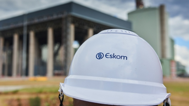 A visitor wears a branded hard hat during a media tour of the Eskom Holdings SOC Ltd. Medupi coal-fired power station in Lephalale, South Africa, on Thursday, May 19, 2022. South Africa’s Eskom is increasing power cuts to prevent a total collapse of the grid as issues grow from lack of imports to breakdowns at its coal-fired plants. Photographer: Waldo Swiegers/Bloomberg