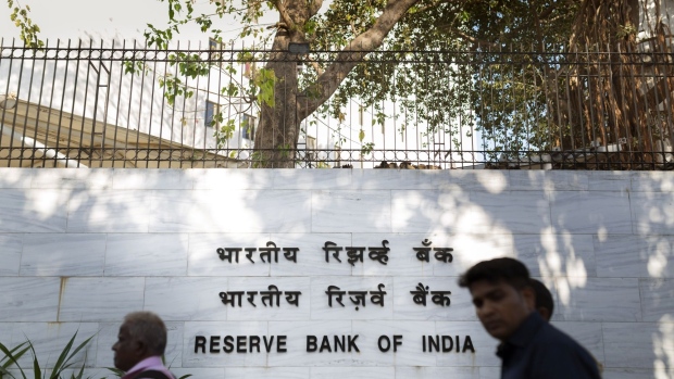 Pedestrians walk past the Reserve Bank of India (RBI) in Mumbai, India, on Tuesday, March 3, 2020. RBI Governor Shaktikanta Das said he's ready to act to shield the economy from the coronavirus and reiterated there's room to cut interest rates if needed. Photographer: Kanishka Sonthali/Bloomberg