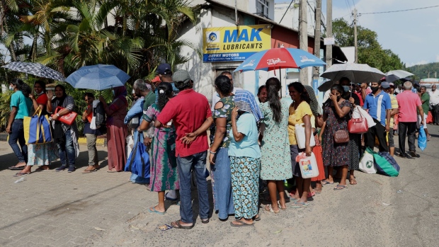 People wait in line to buy kerosene at a gas station in Kandy, Sri Lanka, on June 13. 