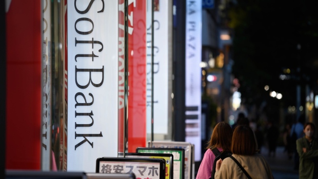 Pedestrians past a SoftBank Corp. store in Tokyo, Japan, on Tuesday, May 10, 2022. SoftBank Group Corp. is scheduled to release its full-year results on May 12. Photographer: Akio Kon/Bloomberg