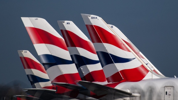 The British Airways livery on the tail fins of passenger aircraft at London Heathrow Airport in London, U.K., on Wednesday, Feb. 23, 2022. International Consolidated Airlines Group SA, the parent company of British Airways, are due to report results on Friday.