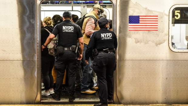 New York Police Department (NYPD) officers enter a subway at a station in New York, US, on Wednesday, May 25, 2022. New York City's subway system is carrying fewer riders than expected this year as crime has spiked, including a fatal shooting on Sunday and a violent subway attack last month that shook the city.