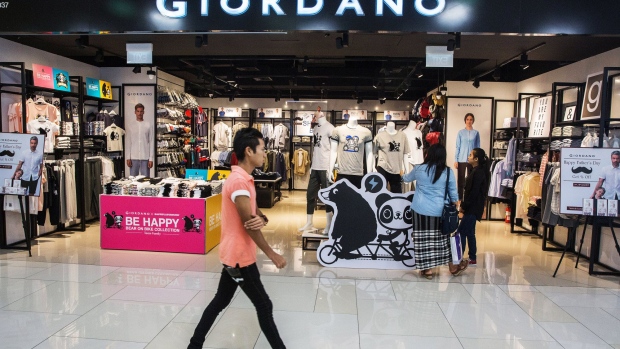 A customer walks past a Giordano International Ltd. store inside the Junction City mall in Yangon, Myanmar on Friday, June 16, 2017. A pariah state for decades, Myanmar’s recent emergence from economic isolation has attracted foreign companies and investors intrigued by the Southeast Asian nation’s untapped potential, abundant natural resources and low wage workforce. Yet some of the initial euphoria over the long-term outlook for one of the world’s last frontier markets is waning.