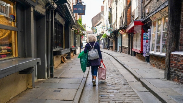 A shopper walks along the Shambles in York, UK, on Monday, June 20, 2022. On Wednesday, inflation is set to rocket to a new 40-year high with the cost of goods leaving factories already racing ahead at a double-digit pace.