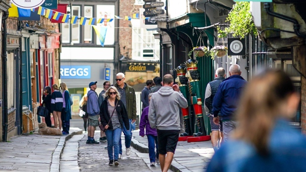 Shoppers walk along a retail street in the city centre of York, UK, on Monday, June 20, 2022. On Wednesday, inflation is set to rocket to a new 40-year high with the cost of goods leaving factories already racing ahead at a double-digit pace.