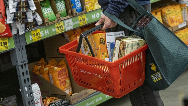 A shopper holds a shopping basket with groceries inside a grocery store in San Francisco, California, U.S., on Monday, May 2, 2022. U.S. inflation-adjusted consumer spending rose in March despite intense price pressures, indicating households still have solid appetites and wherewithal for shopping.