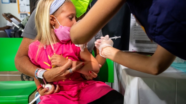 A healthcare worker administers a dose of the Moderna Covid-19 vaccine to a 4 years-old child at the Brooklyn Children's Museum vaccination site, serving children six months to 5-Years old, in the Brooklyn borough of New York, US, on Thursday, June 23, 2022. Covid-19 vaccines for children under 5 years old were authorized by the US Food and Drug Administration on Friday and by the Centers for Disease Control and Prevention on Saturday, a welcome relief to parents of the last age group to become eligible for shots.