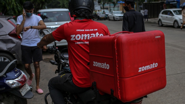 A Zomato Ltd. delivery rider on a motorcycle in Mumbai.