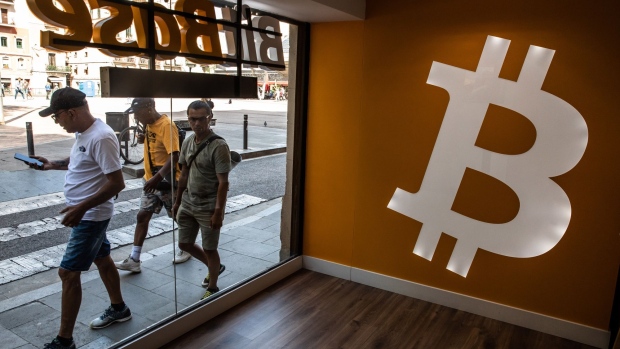 A Bitcoin logo inside a BitBase cryptocurrency exchange in Barcelona, Spain, on Monday, May 16, 2022. The wipeout of algorithmic stablecoin TerraUSD and its sister token Luna knocked more than $270 billion off the crypto sector’s total trillion-dollar value in the most volatile week for Bitcoin trading in at least two years.