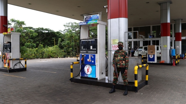 A soldier guards a fuel pump after a gas station ran out of gasoline in Kandy, Sri Lanka, on Friday, June 17, 2022. The government of Sri Lanka declared Friday a holiday for public offices and schools to curtail vehicular movement as the country, facing its worst financial crisis, runs out of fuel for transport and there’s little signs of fresh supplies coming in.