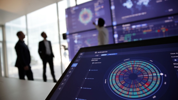 Employees work in the high-tech command center at the Novartis AG campus in Basel, Switzerland, on Wednesday, Jan. 16, 2019. Trying to streamline an operation that spends more than $5 billion a year on developing new drugs, Novartis dispatched teams to jetmaker Boeing Co. and Swissgrid AG, a power company, to observe how they use technology-laden crisis centers to prevent failures and blackouts. Photographer: Stefan Wermuth/Bloomberg