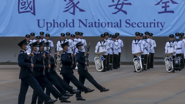 Police officers perform a drill during National Security Education Day at the Hong Kong Police College in 2021. Photographer: Paul Yeung/Bloomberg