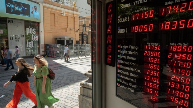 An electronic board displays exchange rates information at a currency exchange bureau in Istanbul, Turkey, on Friday, June 24, 2022. Tourism arrivals in May surged 308% year-on-year, boosting hopes that a rebound in the sector can support the weakening Lira.