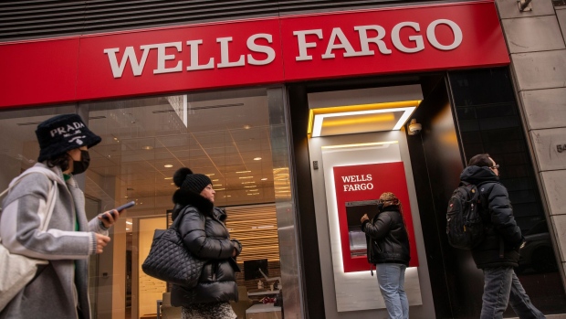 Pedestrians pass a Wells Fargo bank branch in New York, U.S., on Thursday, Jan. 13, 2022. Wells Fargo & Co. said it expects a key measure of lending to pick up this year, a sign that clients are starting to take on debt again as government stimulus wanes. Photographer: Victor J. Blue/Bloomberg