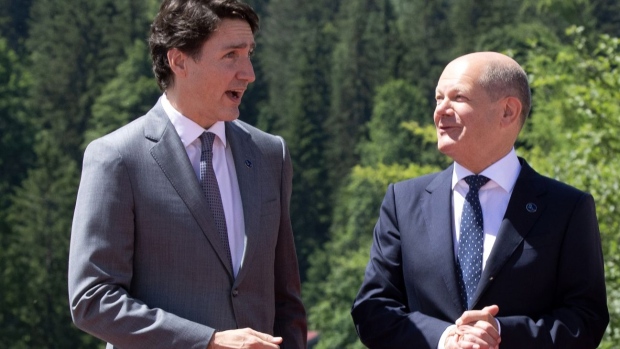 Justin Trudeau, Canada's prime minister, left, welcomed by Olaf Scholz, Germany's chancellor, on the opening day of the Group of Seven (G-7) leaders summit at the Schloss Elmau luxury hotel in Elmau, Germany, on June 26, 2022.