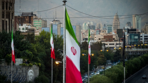 Iranian national flags fly near a major highway through Tehran, Iran, on Tuesday, Sept. 17. 2019. Iranian Foreign Minister Mohammad Javad Zarif refused to rule out military conflict in the Middle East after the U.S. sent more troops and weapons to Saudi Arabia in response to an attack on oil fields the U.S. has blamed on the Islamic Republic. Photographer: Ali Mohammadi/Bloomberg