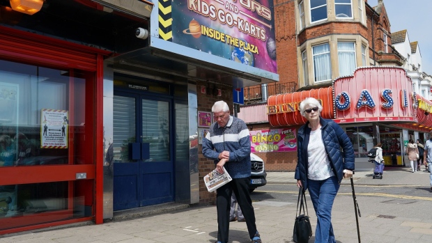 An elderly couple walk along the promenade in Skegness, U.K., on Monday, May 31, 2021. U.K. Health Secretary Matt Hancock said people who want to go on holiday should stay in the U.K. or visit a green-listed country.