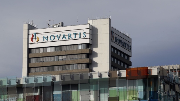A logo sits on display on a building at the Novartis AG campus in Basel, Switzerland, on Wednesday, Jan. 16, 2019. Trying to streamline an operation that spends more than $5 billion a year on developing new drugs, Novartis dispatched teams to jetmaker Boeing Co. and Swissgrid AG, a power company, to observe how they use technology-laden crisis centers to prevent failures and blackouts.