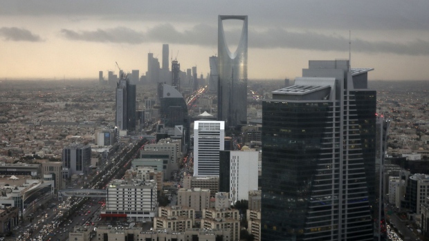 The Kingdom Tower, operated by Kingdom Holding Co., centre, stands on the skyline above the King Fahd highway in Riyadh, Saudi Arabia, on Monday, Nov. 28, 2016. Saudi Arabia and the emirate of Abu Dhabi plan to more than double their production of petrochemicals to cash in on growing demand. Photographer: Simon Dawson/Bloomberg
