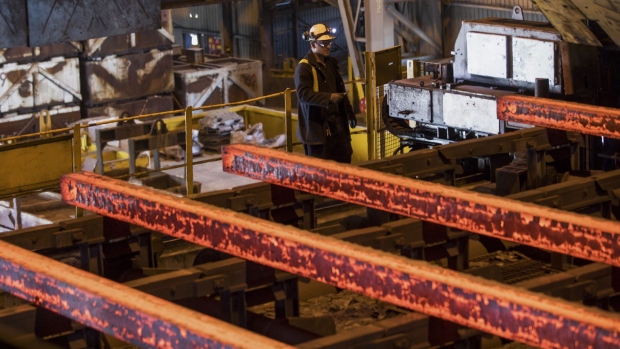 An employee checks a stamping machine for small steel blooms at Liberty Steel's Thrybergh mill in Rotherham, U.K., on Thursday, July 4, 2019. The largest steel industry group in China has urged the government to maintain order in the global iron ore market after prices surged to a five-year high following a supply squeeze, saying that it’s requested authorities look into the gains. Photographer: Chris Ratcliffe/Bloomberg