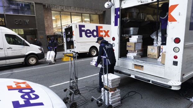 A FedEx Corp. courier prepares packages for delivery during Cyber Monday in the Diamond District neighborhood of New York.