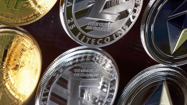 A bitcoin token, left, a litecoin token, centre, and an ethereum token.
