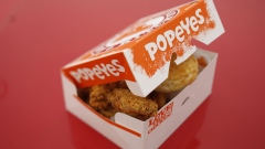 (EDITORS NOTE: Image was created using a variable planed lens.) A box of fried chicken and biscuits is arranged for a photograph outside a Popeyes Louisiana Kitchen Inc. fast food restaurant in Jeffersonville, Indiana, U.S., on Tuesday, Feb. 21, 2017. Restaurant Brands International Inc. agreed to buy Popeyes Louisiana Kitchen Inc. for about $1.8 billion, adding a fried-chicken chain to its lineup of burgers and doughnuts. Photographer: Luke Sharrett/Bloomberg