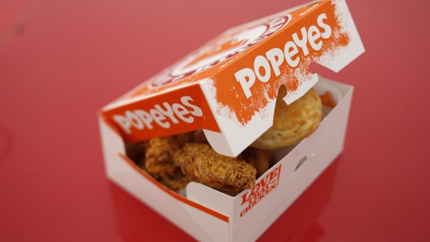 (EDITORS NOTE: Image was created using a variable planed lens.) A box of fried chicken and biscuits is arranged for a photograph outside a Popeyes Louisiana Kitchen Inc. fast food restaurant in Jeffersonville, Indiana, U.S., on Tuesday, Feb. 21, 2017. Restaurant Brands International Inc. agreed to buy Popeyes Louisiana Kitchen Inc. for about $1.8 billion, adding a fried-chicken chain to its lineup of burgers and doughnuts. Photographer: Luke Sharrett/Bloomberg