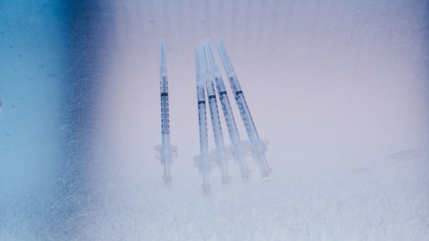 Syringes of the Pfizer-BioNTech Covid-19 vaccine at the University Of Louisville Hospital in Louisville, Kentucky, U.S., on Monday, Dec. 14, 2020. The first Covid-19 vaccine shots were administered by U.S. hospitals Monday, the initial step in a historic drive to immunize millions of people as deaths approach the 300,000 mark.