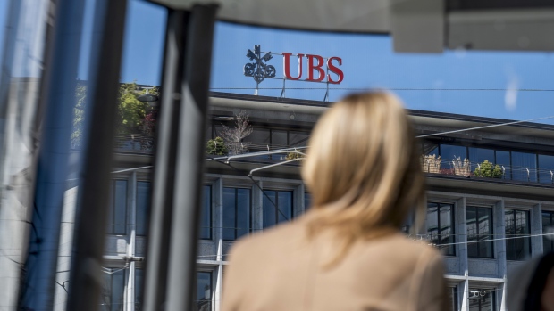 A sign on the roof of a UBS Group AG office building in Zurich, Switzerland, on Tuesday, April 19, 2022. UBS increased pay for junior bankers in the U.S. for a second time in less than a year, bringing the Swiss lender in line with Wall Street rivals trying to stem defections amid a race for talent.