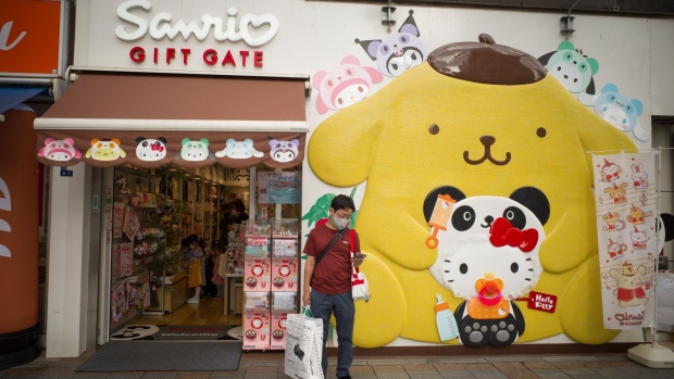 A shopper wearing a protective face mask stands in front of a Sanrio store at the Ameyoko shopping street in Tokyo, Japan, on Sunday, Sept. 5, 2021. Prime Minister Yoshihide Suga's strategy of light virus restrictions for prolonged periods of time has stretched the patience of consumers and business owners while having limited impact on infection rates.