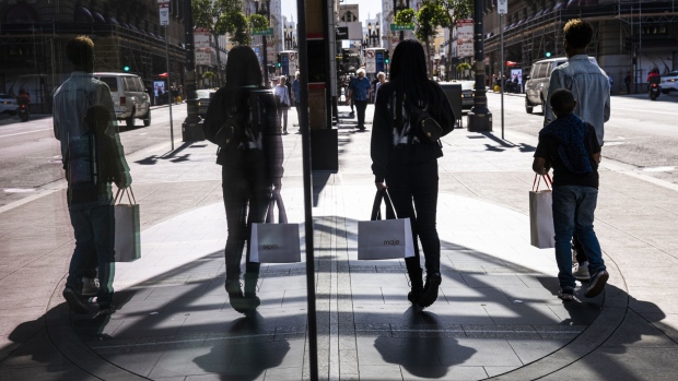 Pedestrians carry shopping bags on Geary street in San Francisco. Photographer: David Paul Morris/Bloomberg