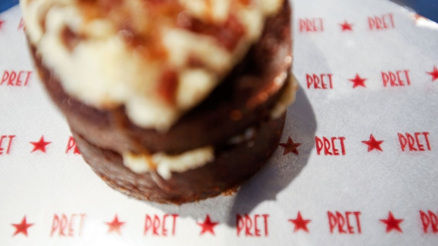 A cake sits on branded paper inside a branch of food retailer Pret a Manger Ltd. in this arranged photograph in London, U.K., on Monday, March 27, 2017. Food chain Pret a Manger said it's concerned about Brexit because just one in 50 applicants seeking jobs is British. Photographer: Luke MacGregor/Bloomberg