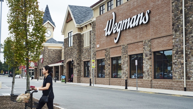 A customer pushes a shopping cart outside of a Wegmans Food Markets Inc. supermarket in in Montvale, New Jersey, U.S., on Tuesday, Oct. 2, 2018. This past September Wegmans opened a new location in Pennsylvania, leaving the company two stores short of a 100-location milestone.