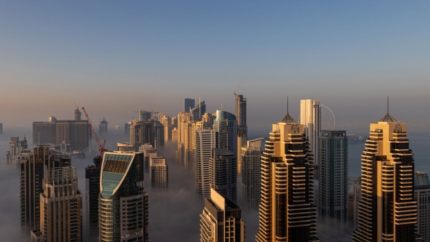 Morning fog shrouds residential and commercial skyscrapers in the Dubai Marina district of Dubai, United Arab Emirates, on Sunday, Jan. 17, 2021. Dubai is hoping one of the world’s fastest vaccination programs and rapid testing technology will help achieve its goal of holding the Expo 2020 event this year, after the coronavirus pandemic forced a delay. Photographer: Christopher Pike/Bloomberg