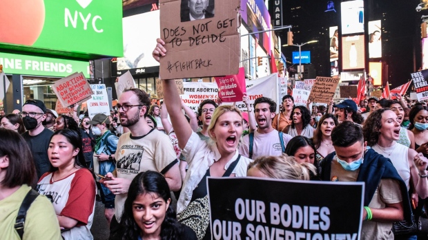 Abortion rights demonstrators hold signs while walking through the streets during a protest in New York, US, on Friday, June 24, 2022. A deeply divided US Supreme Court overturned the 1973 Roe v. Wade decision and wiped out the constitutional right to abortion, issuing a historic ruling likely to render the procedure largely illegal in half the country.